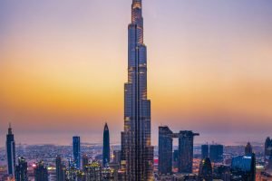 Dubai, United Arab Emirates - July 5, 2019: Burj khalifa rising above Dubai mall and fountain surrounded by modern downtown buildings top view